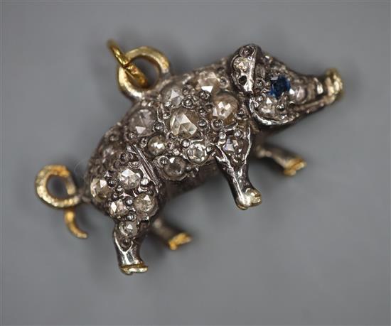 A late Victorian white and yellow metal, rose cut diamond set miniature pig pendant, with sapphire eyes, length 18mm.